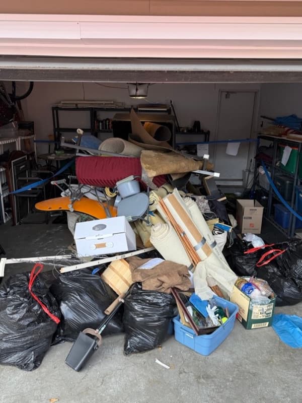 Cluttered garage before junk removal
